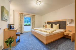 a bedroom with a large bed and a window at Haus Gebhard in Reutte