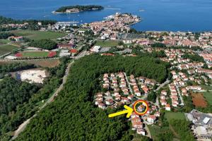 an aerial view of a town with a yellow arrow at Apartments Vera Savic in Poreč