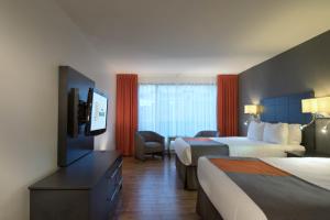 Ένα ή περισσότερα κρεβάτια σε δωμάτιο στο Hôtel Baker