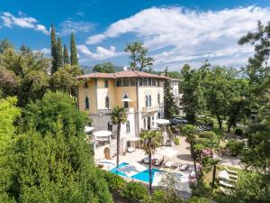 an aerial view of a house with a pool and trees at Hotel Villa Astra in Lovran
