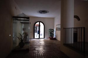 a hallway with a person walking through a building at B&B Pretoria Suite in Potenza