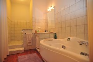 a bathroom with a tub and a shower and a sink at Belsit Bed&Breakfast in Porto San Giorgio