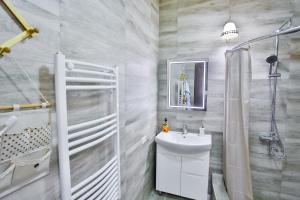 a bathroom with a sink and a shower at Apartment Anano in Kutaisi +30 photos
