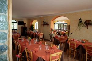 a restaurant with tables and chairs with red tablecloths at Cascina Concetta in Pizzo