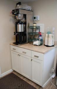 a kitchen counter with a coffee maker on top of it at The Bay Resort in Dewey Beach