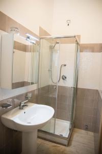 a bathroom with a sink and a shower at B&B "Xenia" in Paestum +24 photos