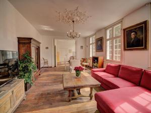 a living room with a red couch and a table at Haus Barkhausen in Monschau