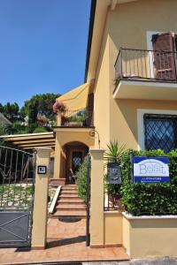 a house with a sign on the front of it at Belsit Bed&Breakfast in Porto San Giorgio