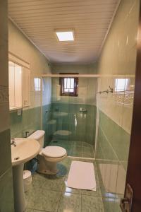 a bathroom with a shower and a toilet and a sink at Cammino Della Serra in Canela