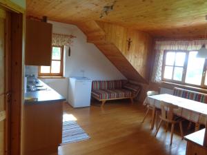 a kitchen and living room in a log cabin at Biohof Stadler in Neustift im Mühlkreis