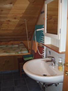 a bathroom with a sink and a staircase in a room at Biohof Stadler in Neustift im Mühlkreis +20 photos