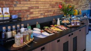 a buffet with different types of food and drinks at Tulip Inn Antwerpen in Antwerp