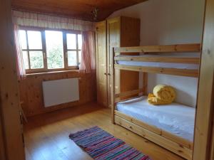 a bedroom with two bunk beds and a window at Biohof Stadler in Neustift im Mühlkreis