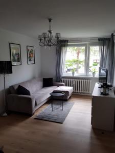 a living room with a couch and a table at Apartament Okrzei in Kłodzko