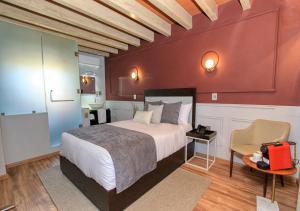 a hotel room with a bed and a chair at Casa Florencia Hotel Boutique in Guanajuato +81 photos