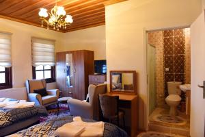 a room with two beds and a living room at ÖZ Butik Otel Antik Kent Myrleia in Mudanya