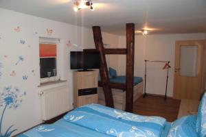 a bedroom with a bunk bed and a tv at Gasthaus Beyersdorfer in Rieth