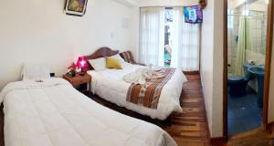 Postel nebo postele na pokoji v ubytování Hostal Comarca Imperial