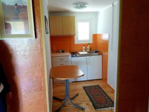 a small kitchen with a stool and a sink at HELONA in Arandjelovac +22 photos
