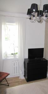 a living room with a couch and a window at Apartament Okrzei in Kłodzko