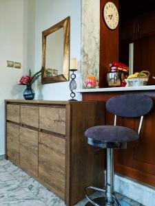 a counter with a bar stool and a mirror at Sailor's Delight in Kavála