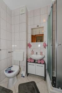 a bathroom with a toilet and a sink at Apartment- SUNCE in Kaštela