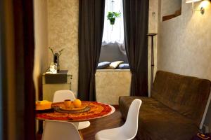 a living room with a table and chairs and a couch at 18 Alfieri in Turin