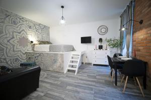 a living room with a bed and a table and chairs at Standard Apartment by Hi5 -Akácfa 57 in Budapest