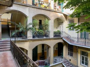 an apartment building with balconies and potted plants at Standard Apartment by Hi5 -Akácfa 57 in Budapest