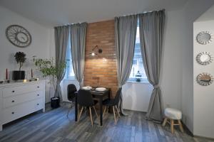 a dining room with a table and a brick wall at Standard Apartment by Hi5 -Akácfa 57 in Budapest