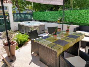 a patio with a table and chairs and a hot tub at Apartment Lemon Tree in Split