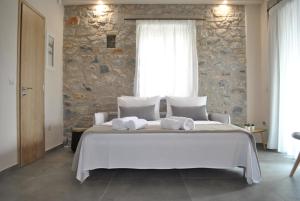 Posteľ alebo postele v izbe v ubytovaní Petras Gi - Stone Houses