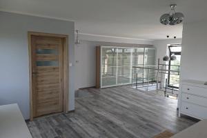 an empty room with a door and a staircase at Apartament Loft 100 m2 Centrum Bydgoszcz in Bydgoszcz
