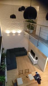 a living room with a couch and a table at Apartament Loft 100 m2 Centrum Bydgoszcz in Bydgoszcz