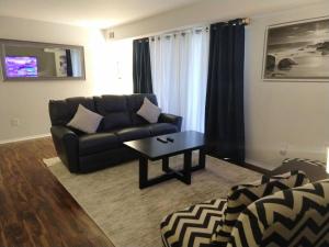 a living room with a couch and a coffee table at Desirable Condo in Central Raleigh in Raleigh