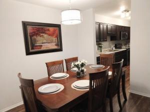 a dining room with a wooden table and chairs at Awesome Condo in Central Raleigh in Raleigh