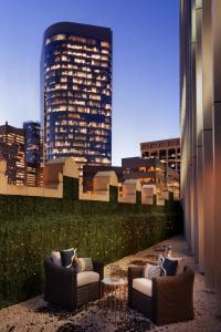 a rooftop patio with two chairs and a building at EXchange Hotel Vancouver in Vancouver