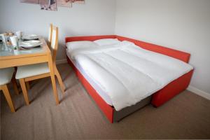 a bed in a room with a desk and a bed sidx sidx sidx at Sea Road Apartments in Bournemouth