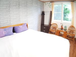 Voodi või voodid majutusasutuse Shan Shui-Yuan Vege Guest House toas