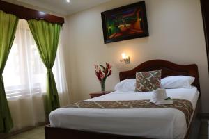 Ένα ή περισσότερα κρεβάτια σε δωμάτιο στο Hotel SueñoReal RioCeleste