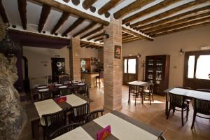 a restaurant with tables and chairs in a room at Hotel Rural La Sal in Salinas de Hoz