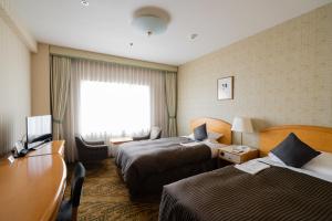 Postel nebo postele na pokoji v ubytování Hotel Okura Niigata