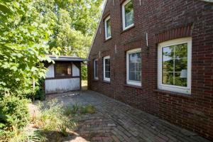 a brick building with a garage on the side of it at 50058... in Altfunnixsiel