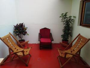 
a living room filled with furniture and a red chair at Secret Garden in Cusco
