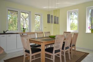 a kitchen with a wooden table and chairs at Ferienhaus Sonne in Cottbus