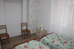 Postel nebo postele na pokoji v ubytování Guest House Lviv Грузия
