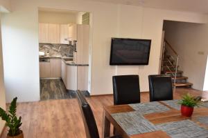 a living room with a dining room table and a television at Apartmán-Hovorany in Hovorany