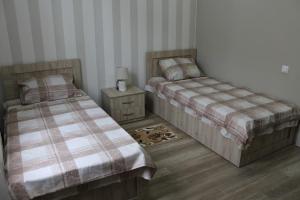 Postel nebo postele na pokoji v ubytování Guest House Lviv Грузия