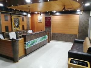 a lobby with a waiting room with a reception desk at Hotel Nandnandan in Dwarka