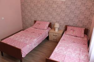 Postel nebo postele na pokoji v ubytování Guest House Lviv Грузия